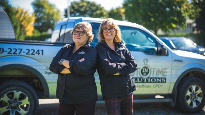 two women standing back to back