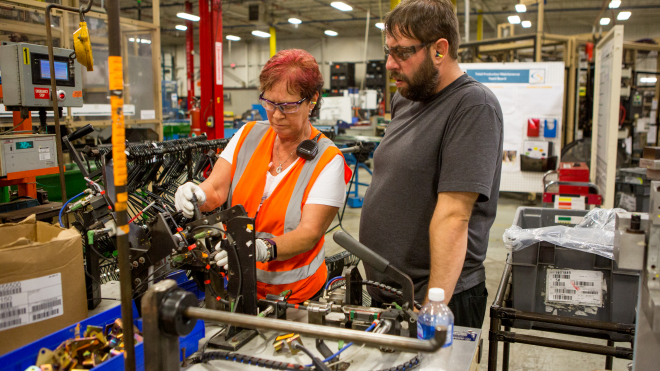 Two workers working with machinery