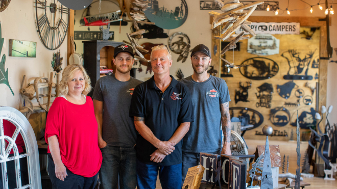 Family with metal murals in the back 