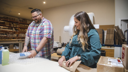 Man and woman packing boxes