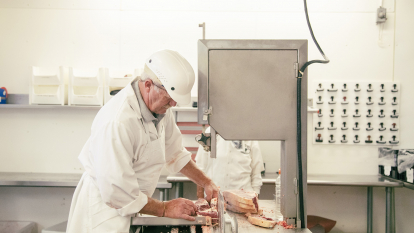 Butcher cutting meat 